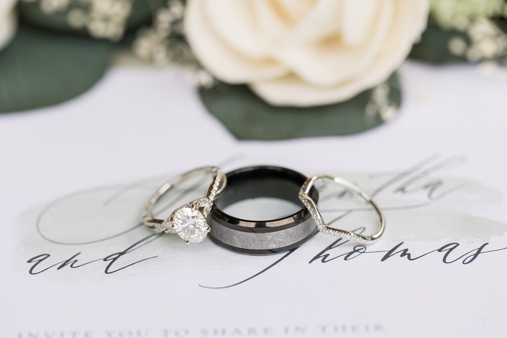 Wedding rings displayed on top of wedding invitations | Rustic Wedding | Twin Oaks Barn Wedding | Twin Oaks Barn Wedding Photographer | Raleigh NC Wedding Photographer