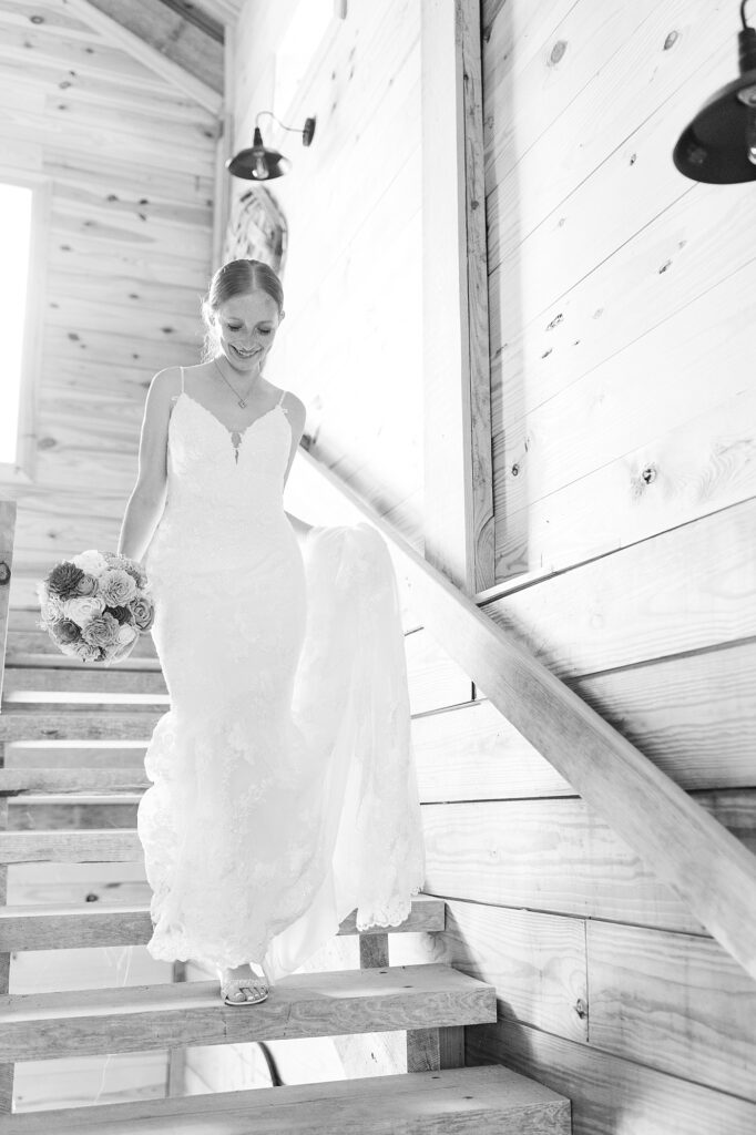 Bride walking down stairs holding bouquet | Rustic Wedding | Twin Oaks Barn Wedding | Twin Oaks Barn Wedding Photographer | Raleigh NC Wedding Photographer