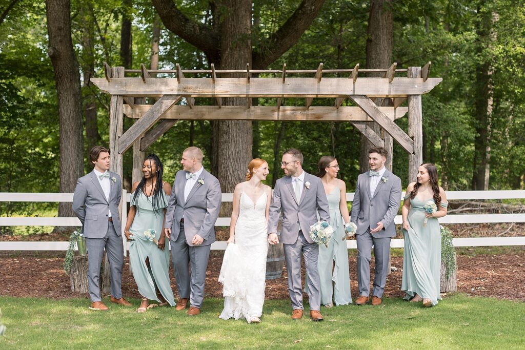 Bride and groom smiling with wedding party | Rustic Wedding | Twin Oaks Barn Wedding | Twin Oaks Barn Wedding Photographer | Raleigh NC Wedding Photographer
