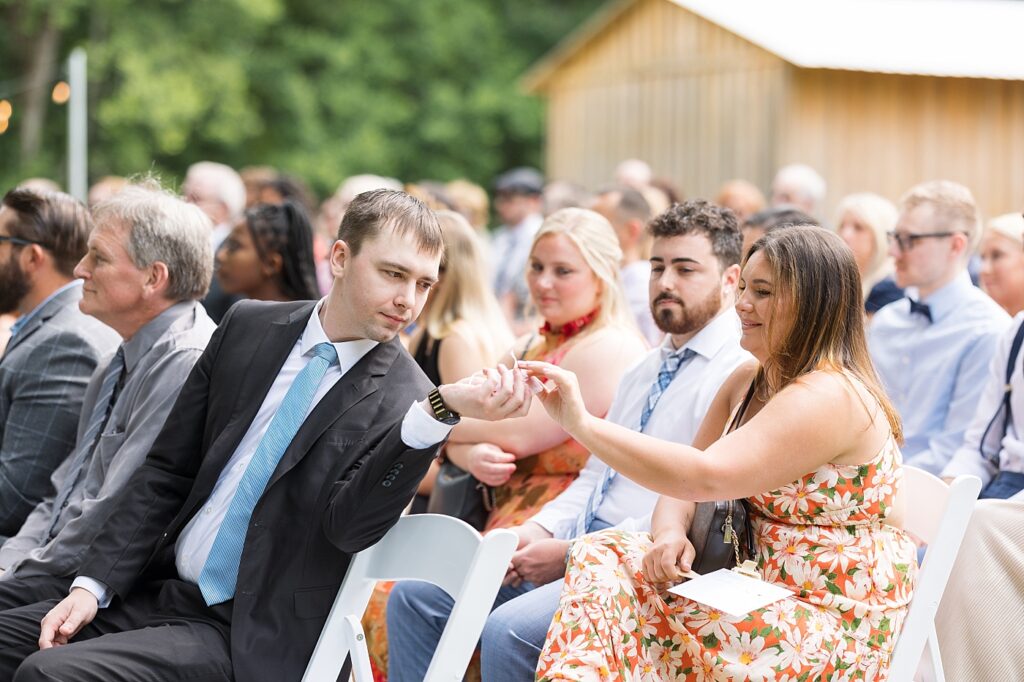 Wedding guests touching wedding rings during ring warming ceremony  | Rustic Wedding | Twin Oaks Barn Wedding | Twin Oaks Barn Wedding Photographer | Raleigh NC Wedding Photographer
