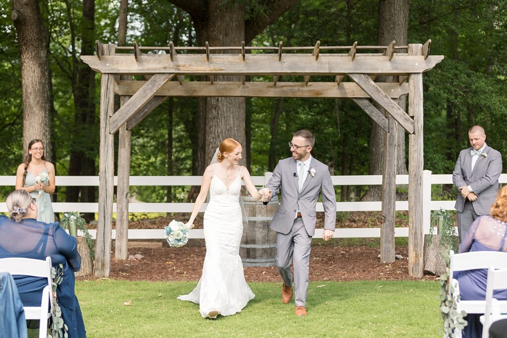 Bride and groom walking down aisle after wedding ceremony | Rustic Wedding | Twin Oaks Barn Wedding | Twin Oaks Barn Wedding Photographer | Raleigh NC Wedding Photographer