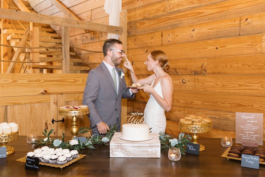 Bride and groom tasting wedding cake | Rustic Wedding | Twin Oaks Barn Wedding | Twin Oaks Barn Wedding Photographer | Raleigh NC Wedding Photographer