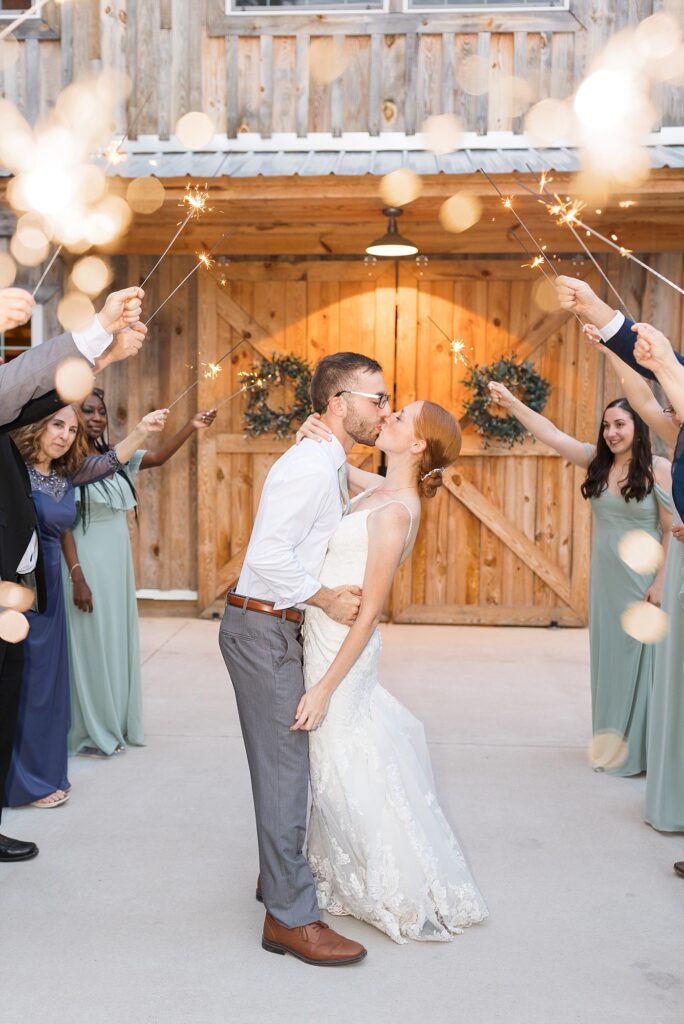 Bride and groom kissing during sparkler exit | Rustic Wedding | Twin Oaks Barn Wedding | Twin Oaks Barn Wedding Photographer | Raleigh NC Wedding Photographer