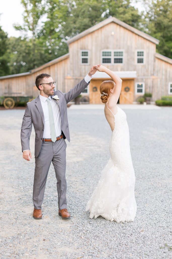 Groom twirling bride outside barn | Rustic Wedding | Twin Oaks Barn Wedding | Twin Oaks Barn Wedding Photographer | Raleigh NC Wedding Photographer