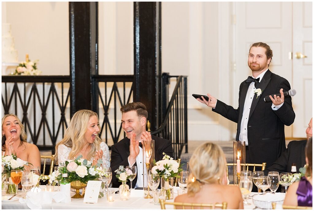 Bride and groom laughing during groomsman's toast | Classic Summer Wedding | Wedding with Neutrals | Carolina Inn Wedding on The Lawn | UNC Alumni Wedding | Raleigh Wedding Photographer | NC Wedding Photographer