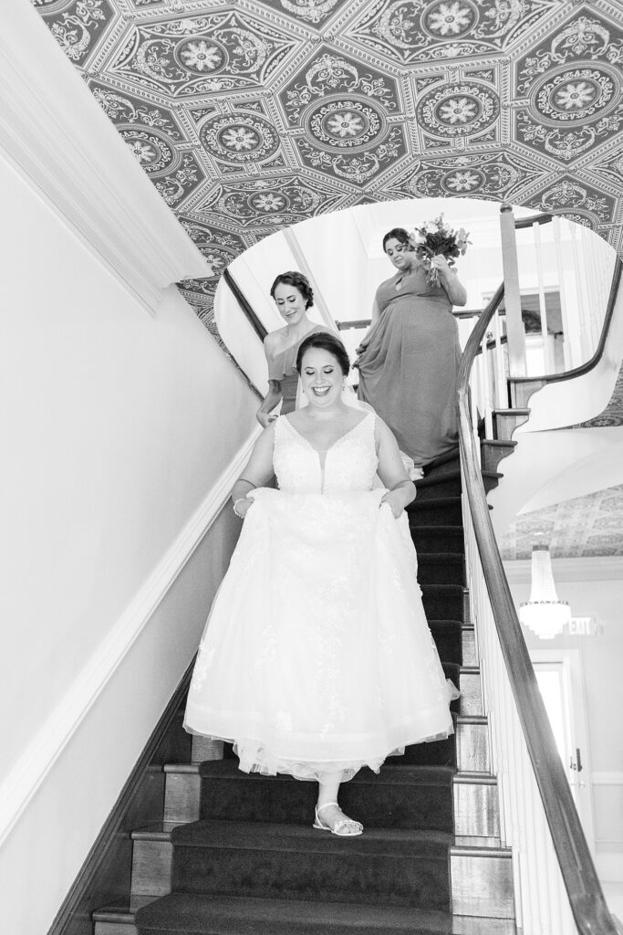 Bride and bridesmaids walking down the stairs | Summer Wedding | The Matthews House Wedding | The Matthews House Wedding Photographer | Raleigh NC Wedding Photographer