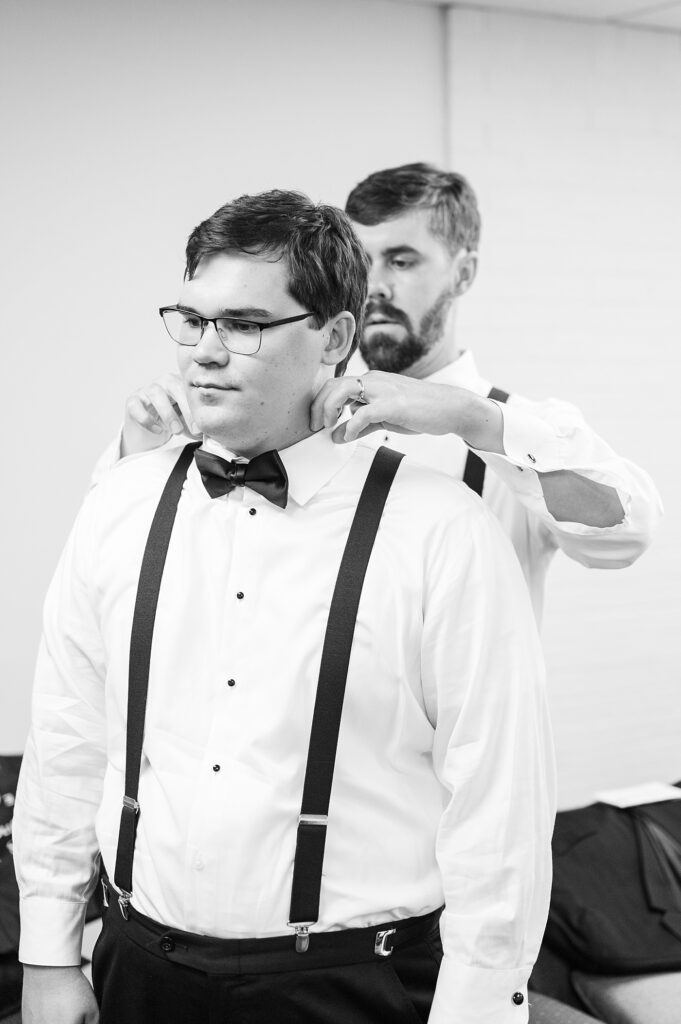 Groomsman helping groom adjust shirt collar | Summer Wedding | The Matthews House Wedding | The Matthews House Wedding Photographer | Raleigh NC Wedding Photographer