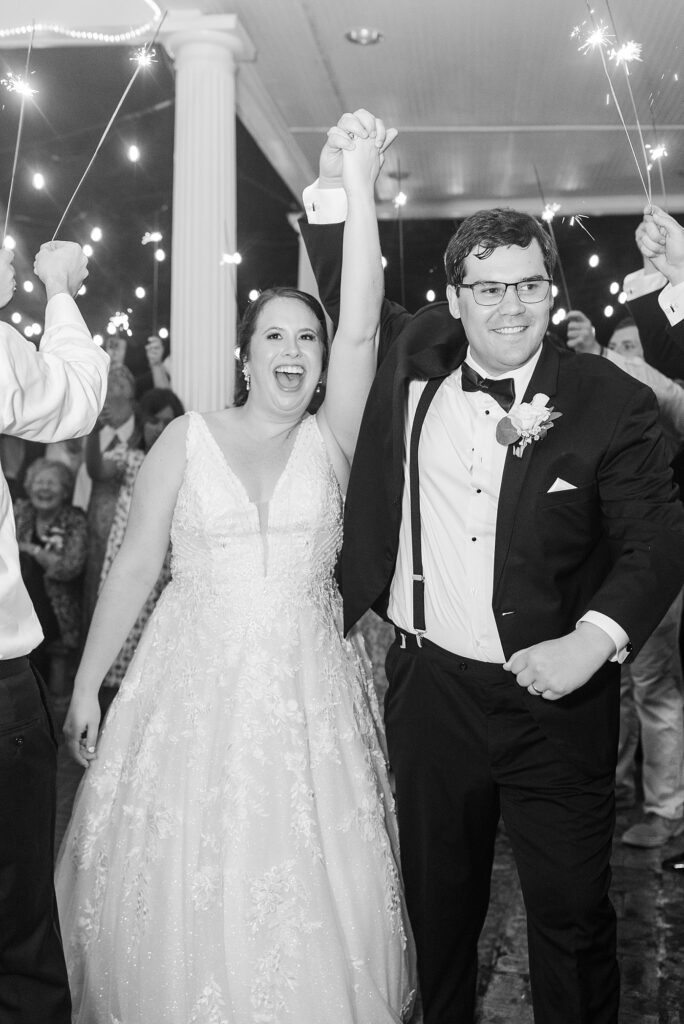 Bride and groom holding hands during sparkler exit | Summer Wedding | The Matthews House Wedding | The Matthews House Wedding Photographer | Raleigh NC Wedding Photographer