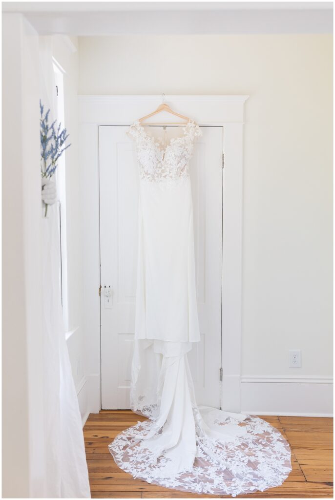 Wedding dress hanging from door frame | Caffe Luna Wedding | Caffe Luna Wedding Photographer | Raleigh NC Wedding Photographer