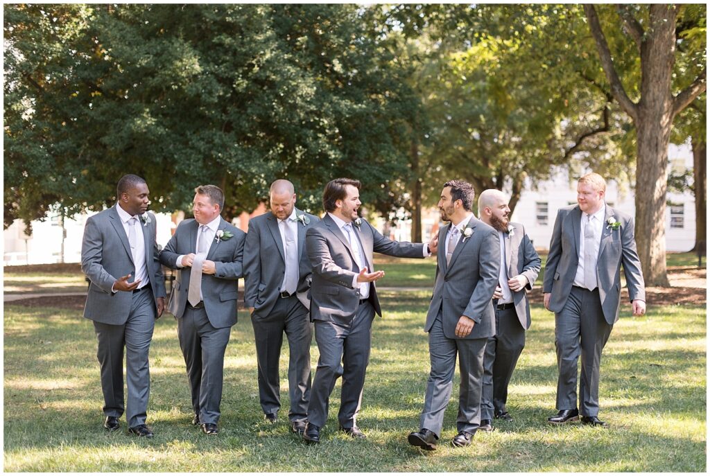 Groom walking with groomsmen | Caffe Luna Wedding | Caffe Luna Wedding Photographer | Raleigh NC Wedding Photographer