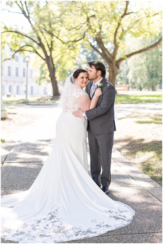 Groom kissing bride on forehead | Caffe Luna Wedding | Caffe Luna Wedding Photographer | Raleigh NC Wedding Photographer