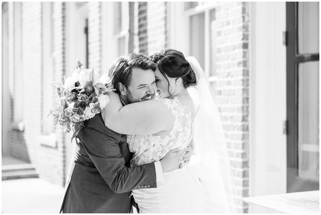 Bride and groom embracing after wedding ceremony | Caffe Luna Wedding | Caffe Luna Wedding Photographer | Raleigh NC Wedding Photographer