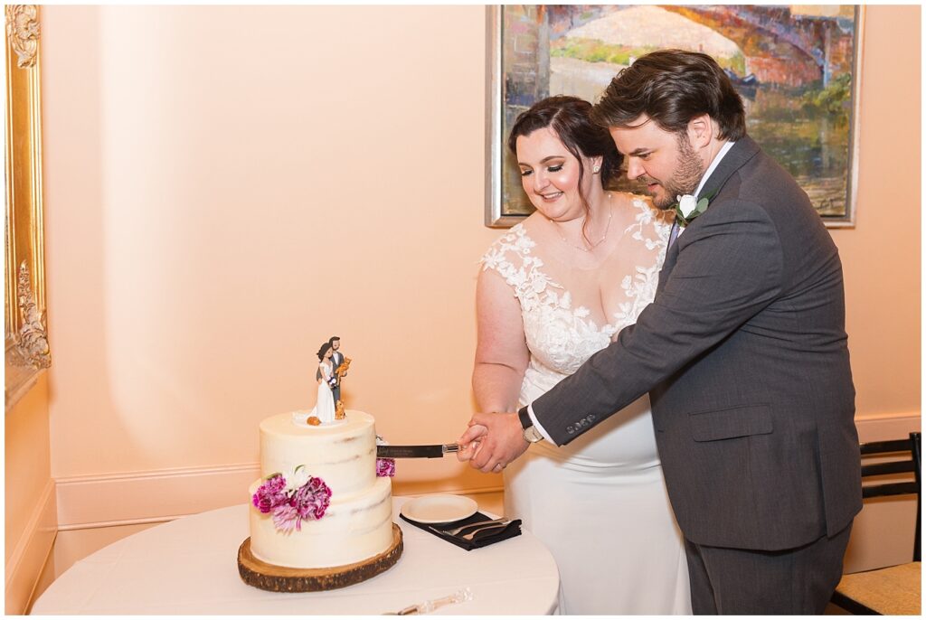 Bride and groom cutting wedding cake | Caffe Luna Wedding | Caffe Luna Wedding Photographer | Raleigh NC Wedding Photographer