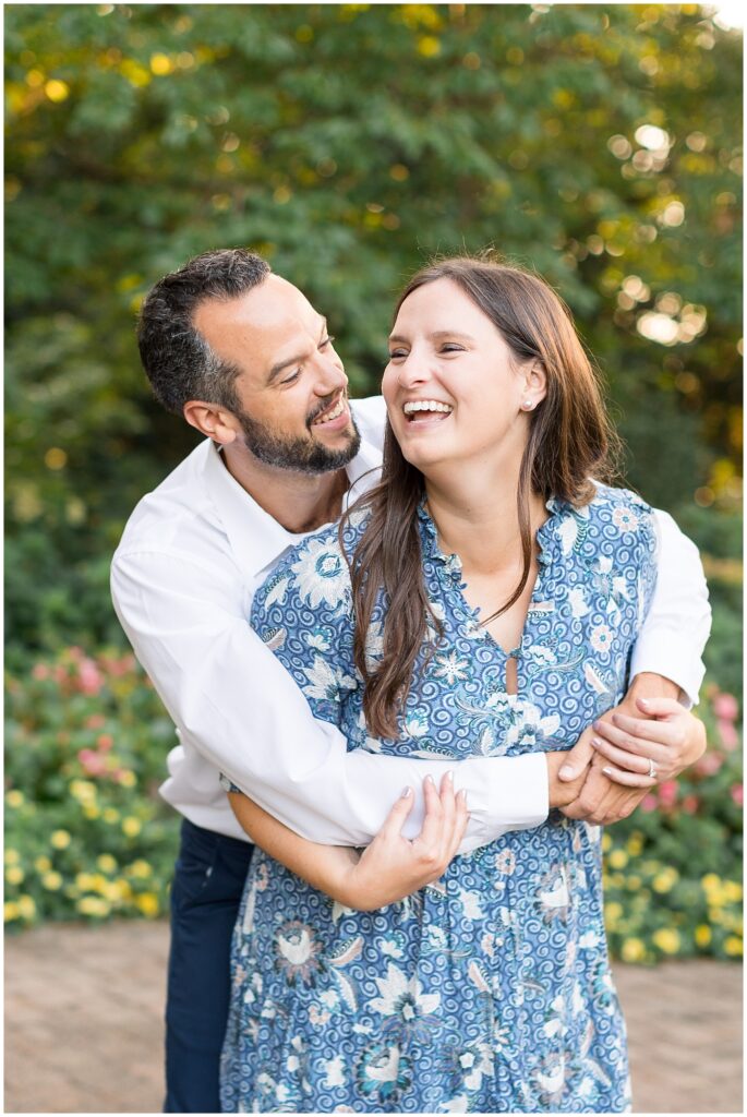 Couple smiling in garden | WRAL Gardens engagement photos | Raleigh NC wedding photographer 
