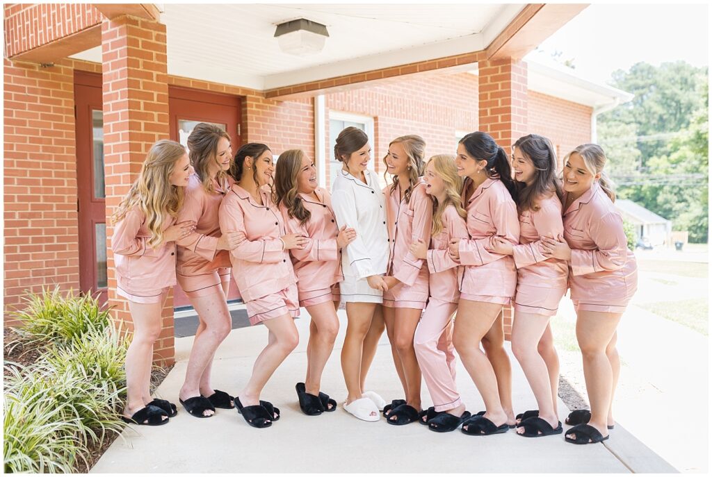 Bride and bridesmaids smiling in pajamas | Summer Wedding | Angus Barn Wedding | Angus Barn Wedding Photographer | Raleigh NC Wedding Photographer