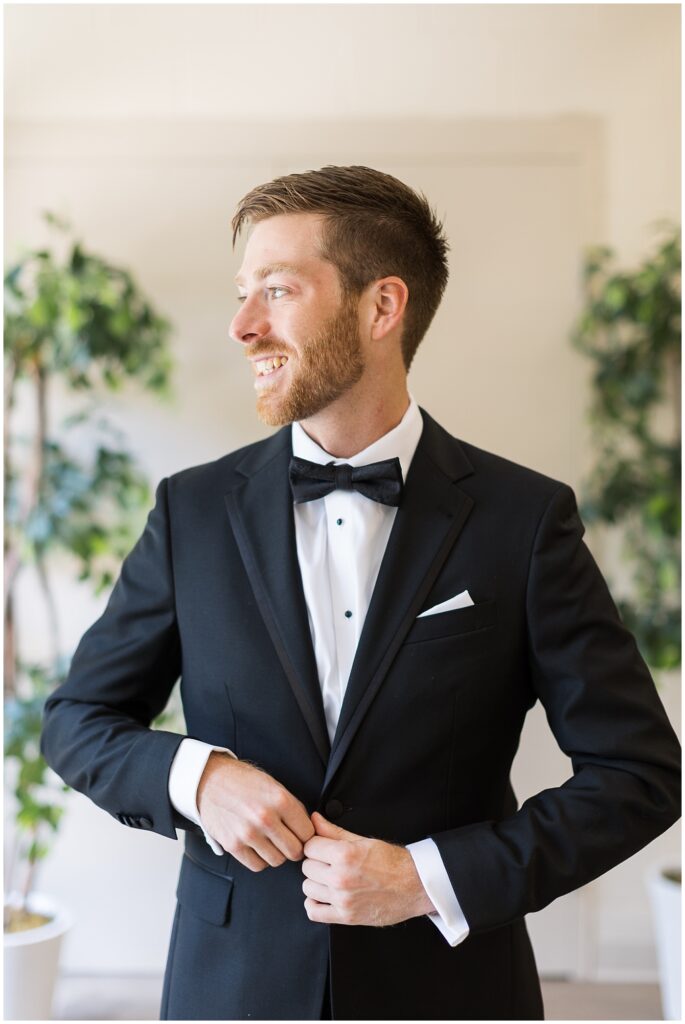 Groom buttoning suit jacket | Summer Wedding | Angus Barn Wedding | Angus Barn Wedding Photographer | Raleigh NC Wedding Photographer