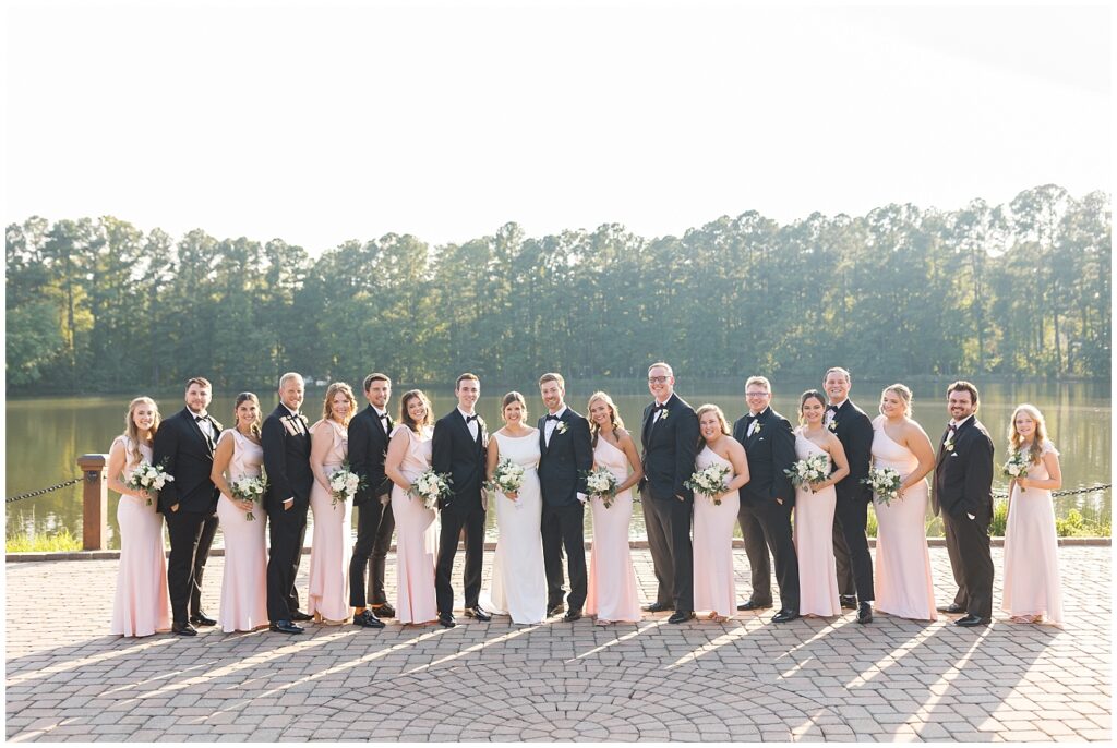 Wedding party standing by lake | Summer Wedding | Angus Barn Wedding | Angus Barn Wedding Photographer | Raleigh NC Wedding Photographer