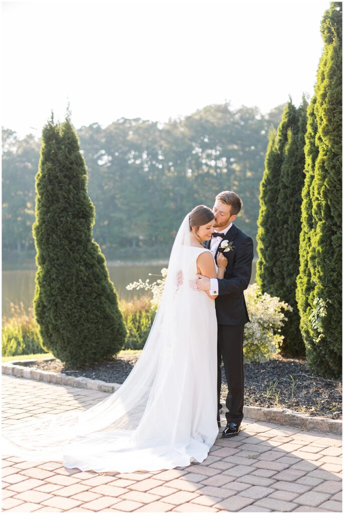 Bride and groom posing inspiration by lake | Summer Wedding | Angus Barn Wedding | Angus Barn Wedding Photographer | Raleigh NC Wedding Photographer