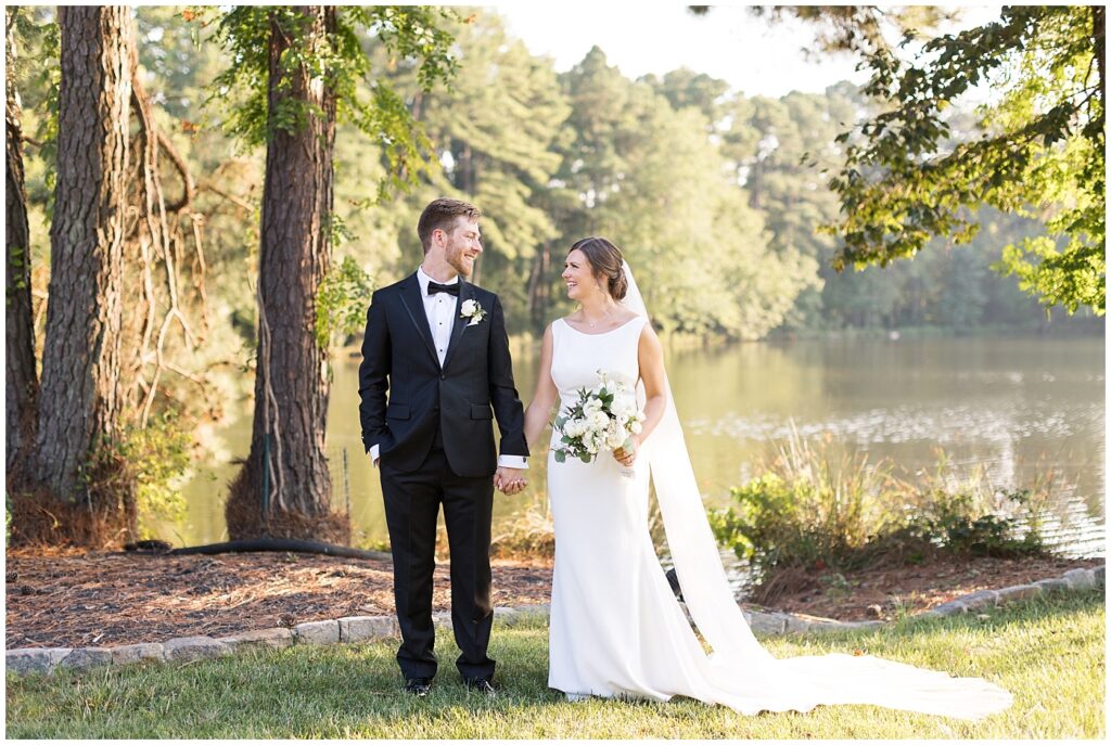 Bride and groom posing inspiration by lake | Summer Wedding | Angus Barn Wedding | Angus Barn Wedding Photographer | Raleigh NC Wedding Photographer