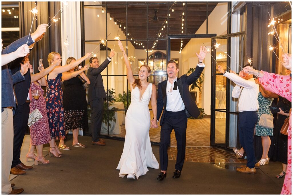 Bride and groom holding hands during sparkler exit | The Meadows Wedding | The Meadows Wedding Photographer | Raleigh NC Wedding Photographer
