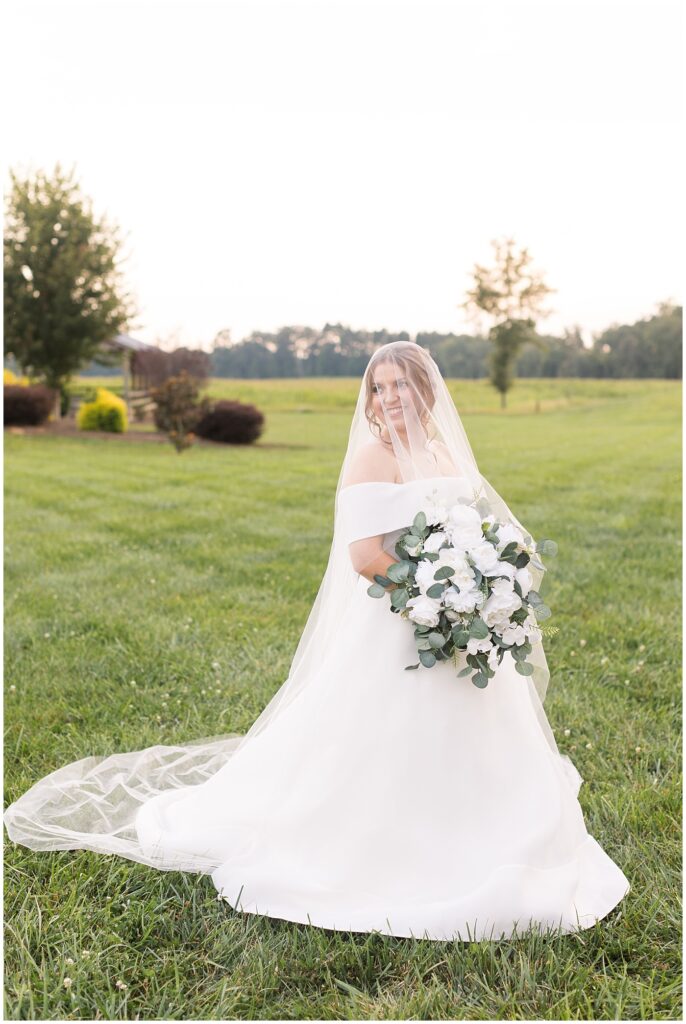 Bride wearing veil over face and holding white bouquet | Bridal Portraits at The Farmstead | Raleigh NC Wedding Photographer | Bridal Portrait Photographer