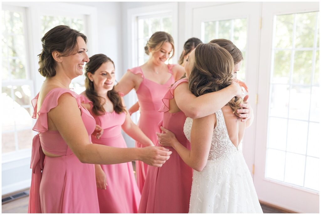 Bridesmaids embracing bride | The Meadows Wedding | The Meadows Wedding Photographer | Raleigh NC Wedding Photographer