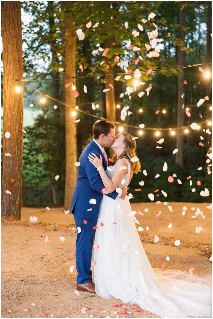 Bride and groom kissing under falling rose petals | The Meadows Wedding | The Meadows Wedding Photographer | Raleigh NC Wedding Photographer