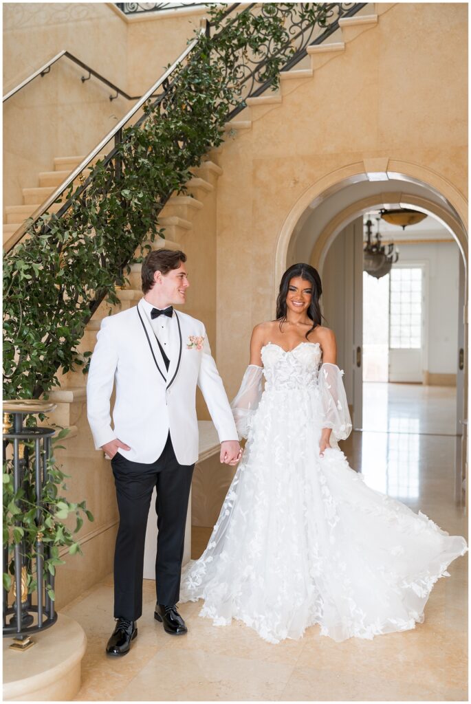 Bride and Groom Holding Hands Near Stairwell | Hallway Wedding Photos