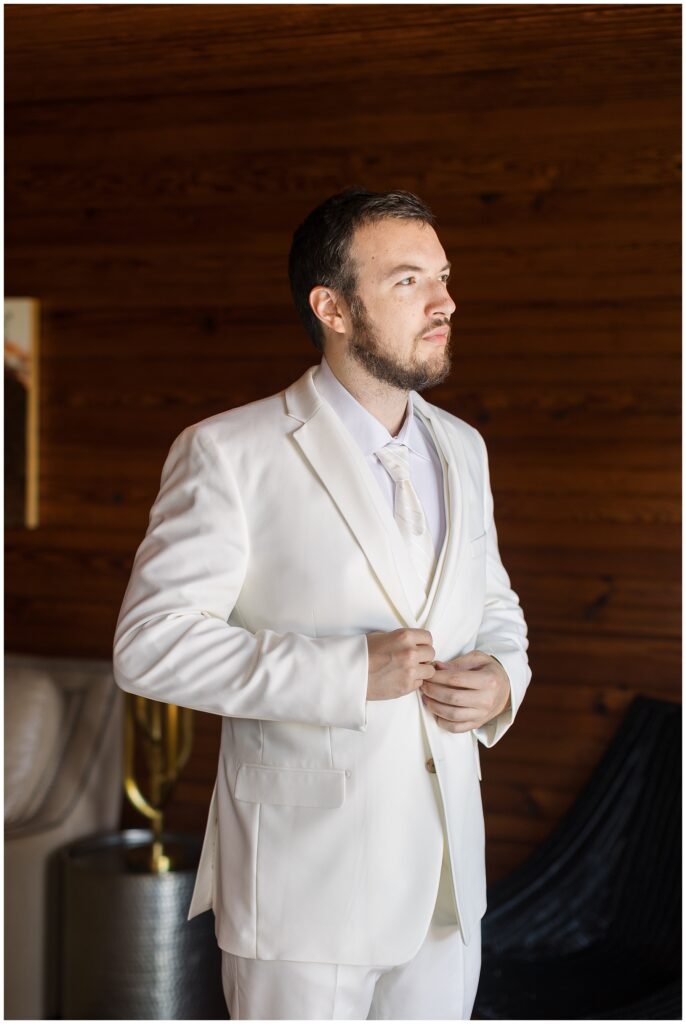 Groom getting ready in a white suit for summer wedding | Wedding Day Inspiration | Raleigh Wedding Photographer