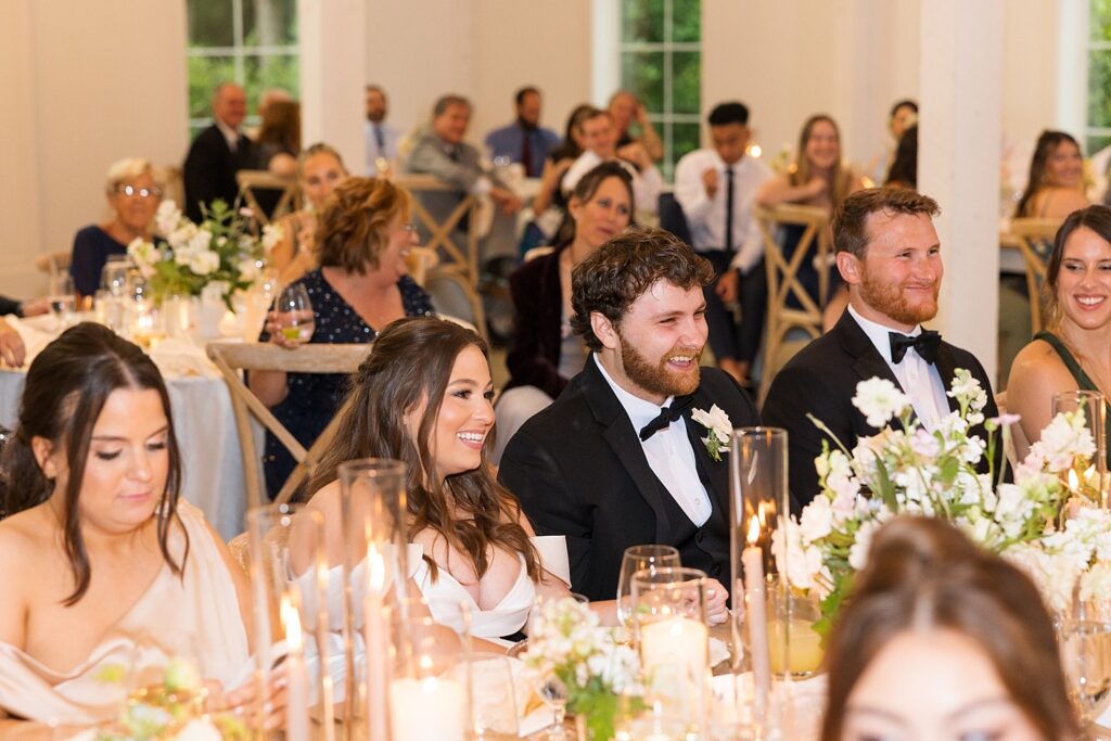 bride and groom smiling | wedding speeches | wedding toasts | carolina grove wedding | carolina grove wedding photographer | classic wedding venue 