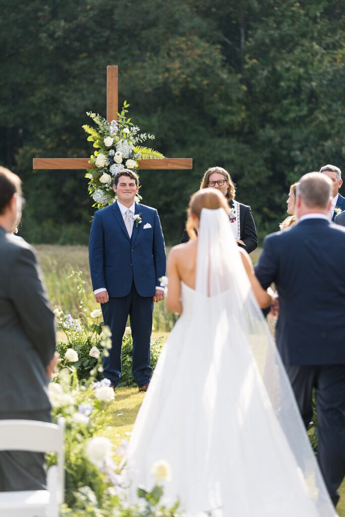groom at ceremony, bride walking down the aisle, the legacy at willow pond, outdoor ceremony, historic venues in Virginia, classic wedding venue