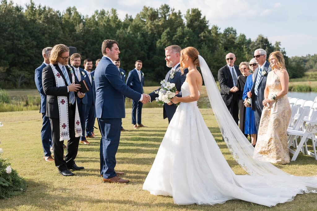 groom at ceremony, bride walking down the aisle, the legacy at willow pond, outdoor ceremony, historic venues in Virginia, classic wedding venue