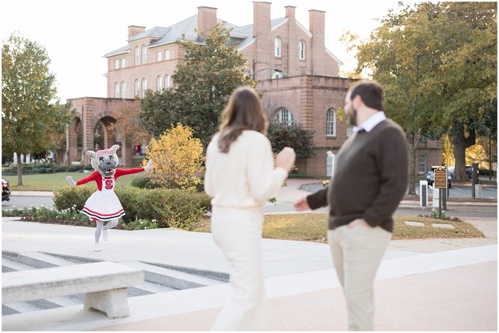 Engagement photos with a suprise appearance of Mrs. Wuf at the NC State Bell Tower
