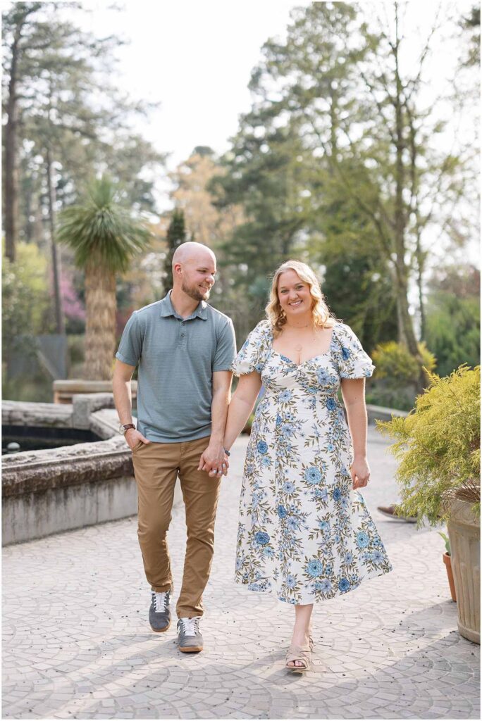 Spring engagement photos walking through Duke Gardens during cherry blossom season